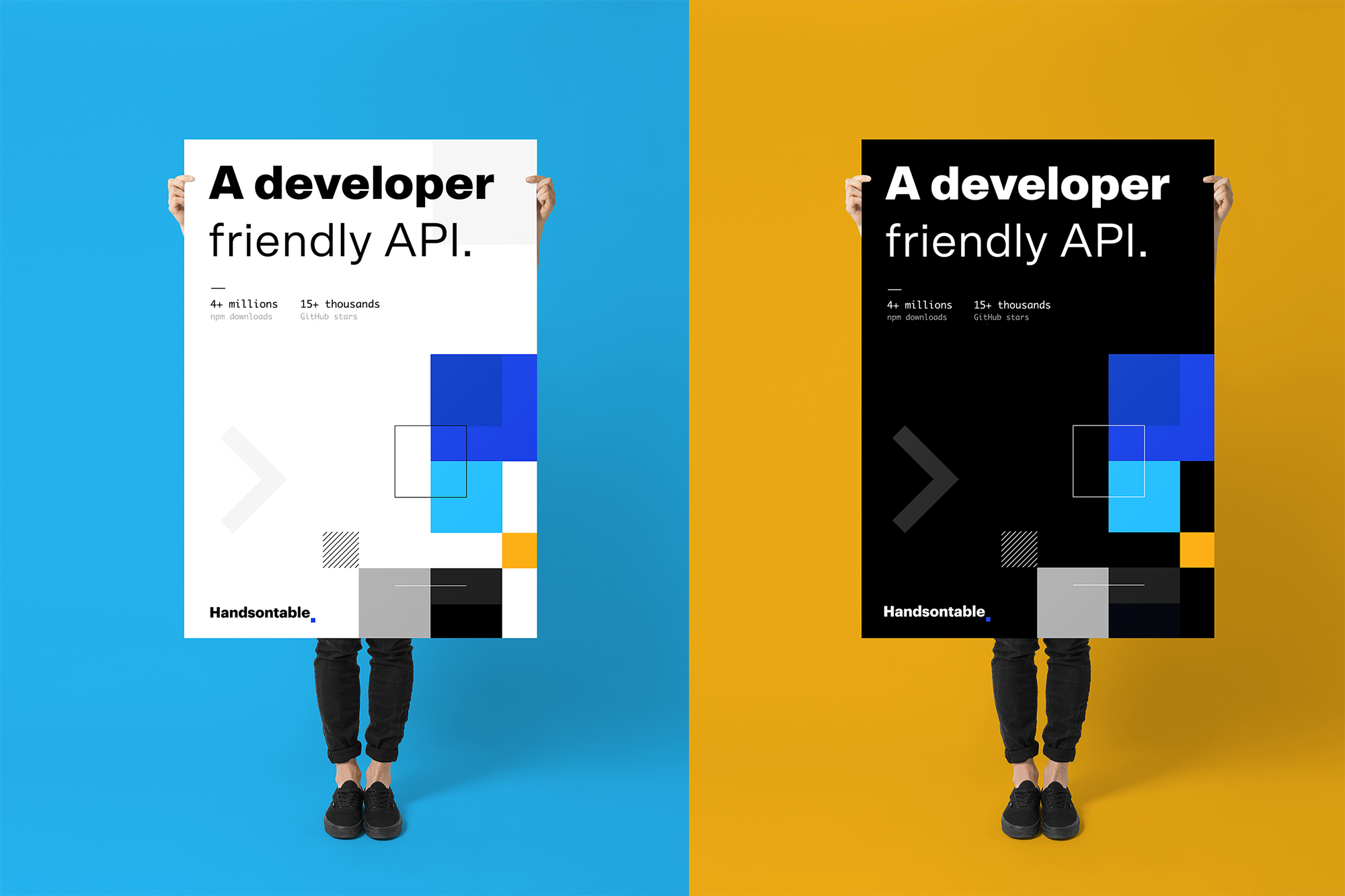 Two people holding Handsontable posters reading “A developer friendly API.”, one light and one dark